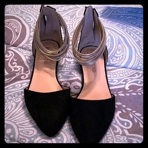 Black flats with metallic gold ankle straps